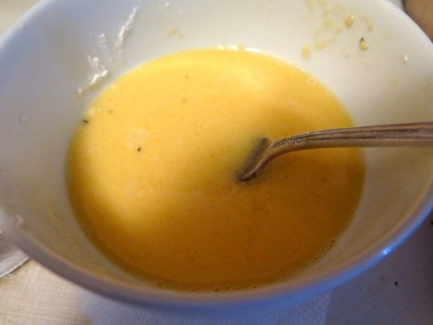 After a light flouring, a quick dip in the egg/water mix.