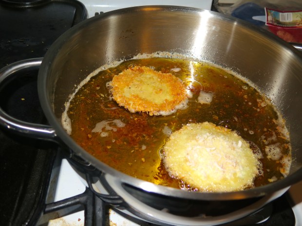 Fry (yes, I said it, fry) in olive oil.  Not a super light extra virgin, something heavier that will hold up.