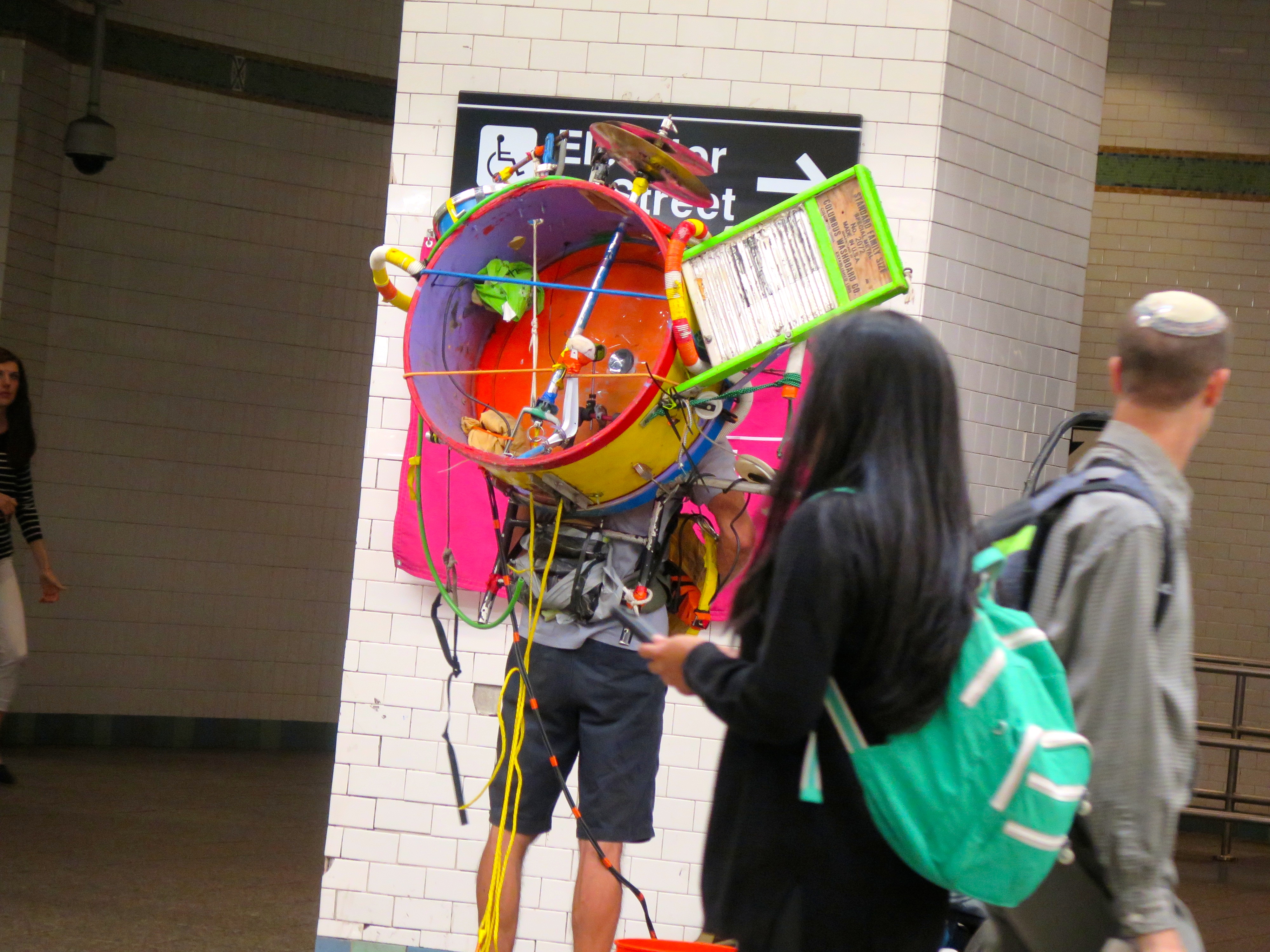 Yes indeed, that's the back of a one-man-band. An optimistic one, with a 5-gallon Home Depot bucket for a tip jar.